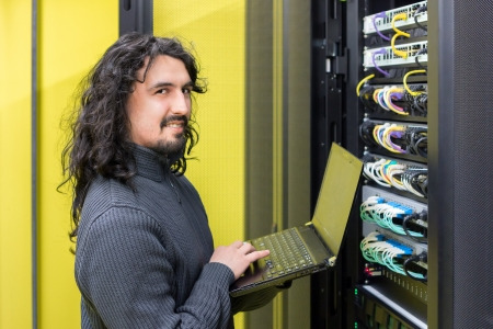 Engineer performing a network inventory in a server room